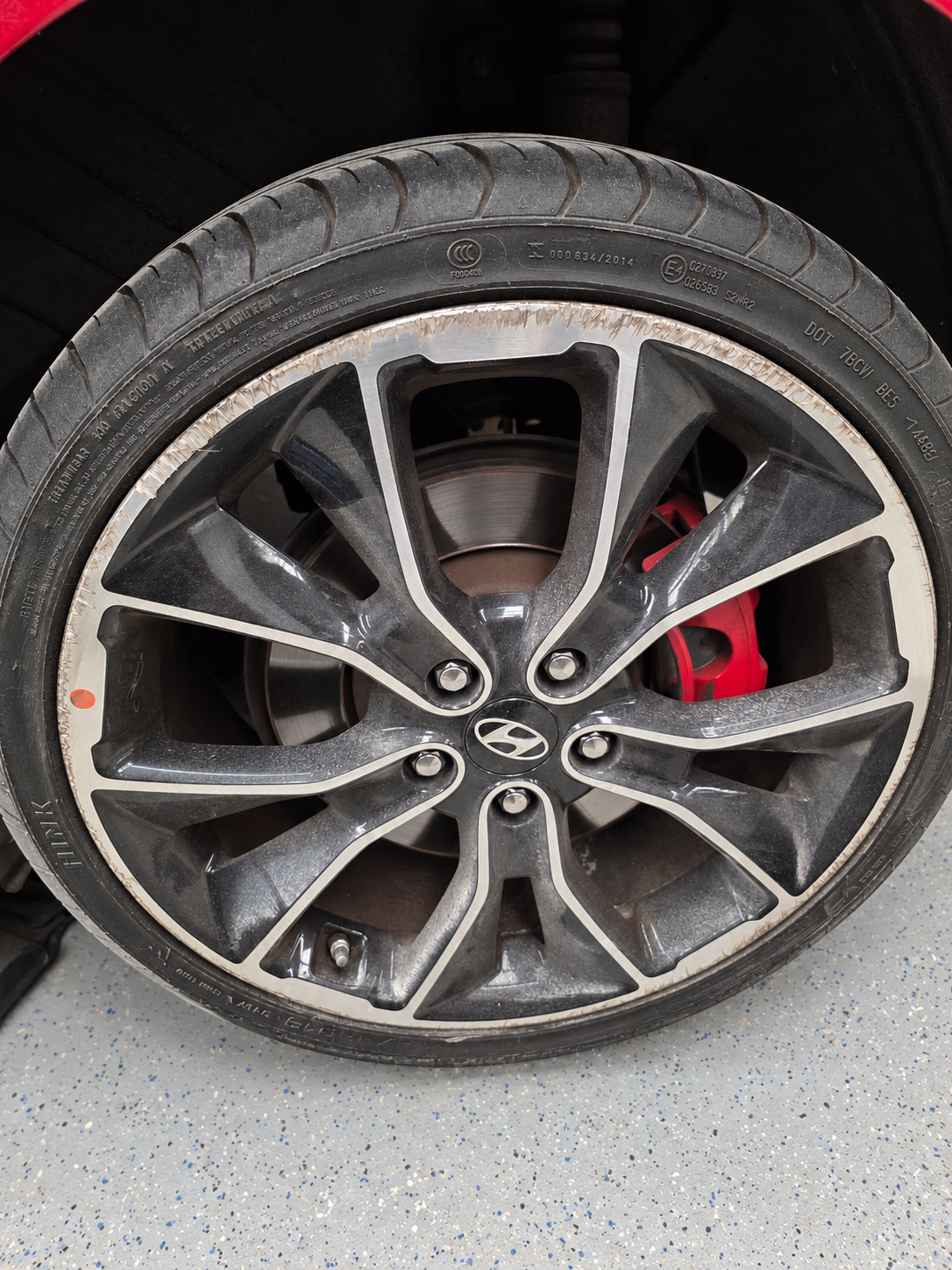 Hyundai rim before repair with kerb rash